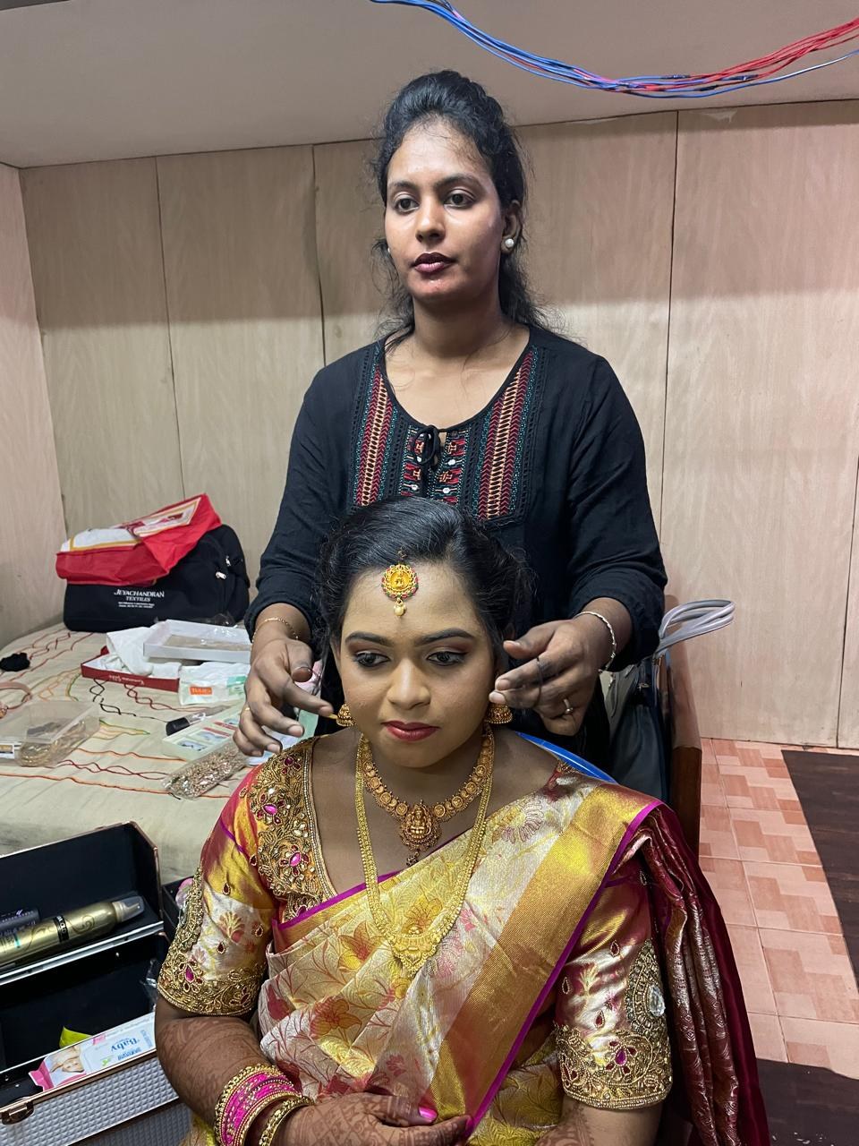 Kalaipriya R K finishing a bridal look in gold jewellery