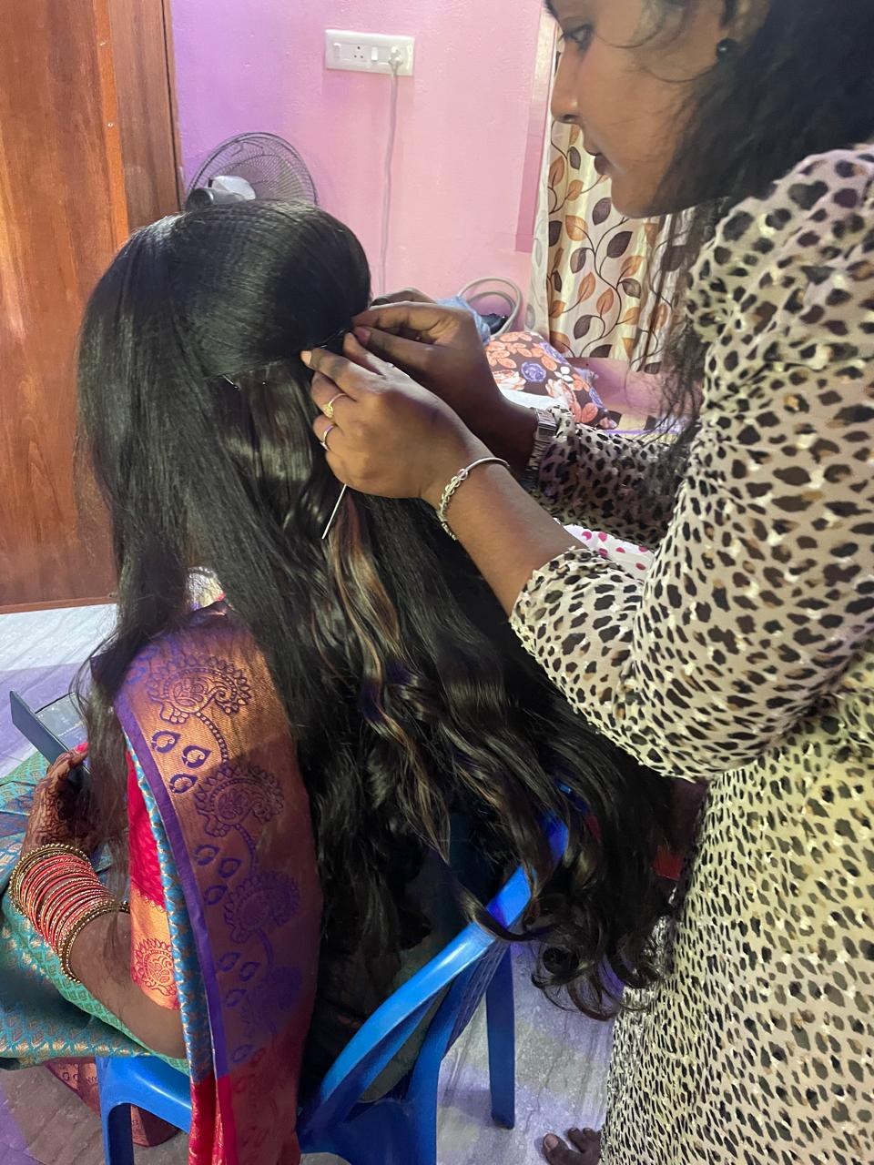 Kalaipriya R K styling a bride's hair