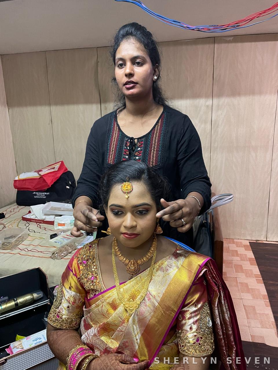 Bride in a gold silk saree with traditional jewellery, finishing touches