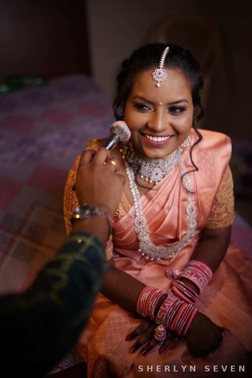 Candid bridal ceremony moment with garland and gold jewellery
