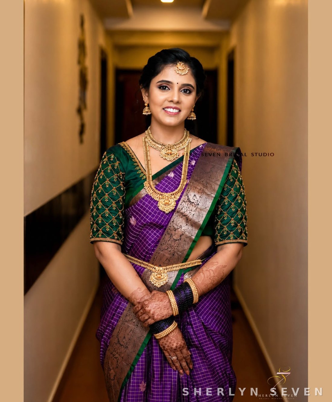 Reception look in a purple and gold saree